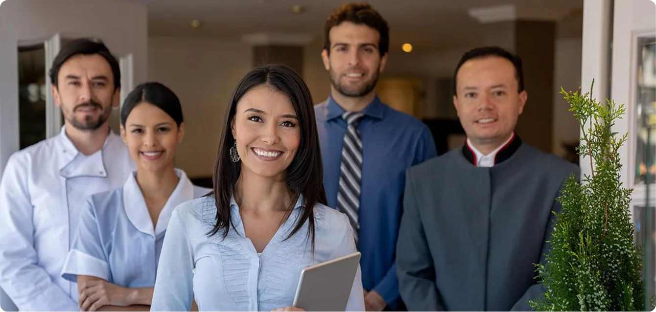Five hospitality staff smiling
