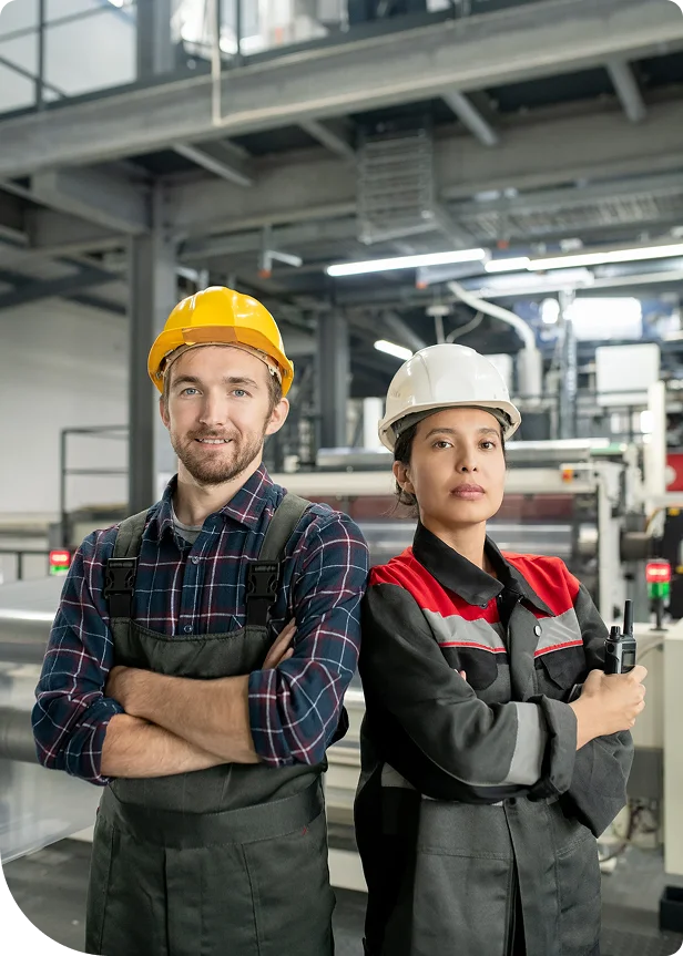 Manufacturing workers in hard hats at a production facility in Delta