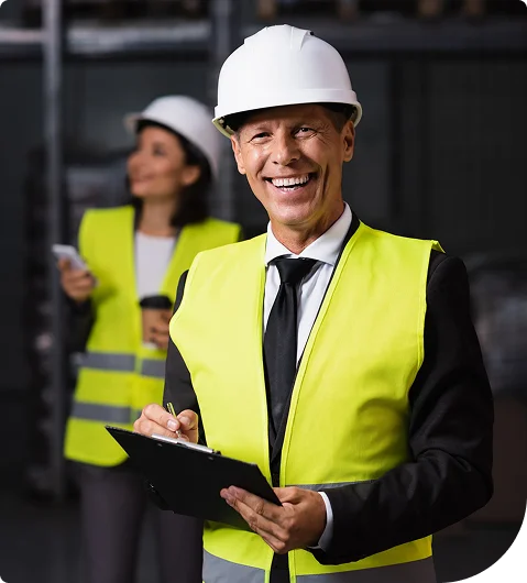 Site supervisor in a hard hat and safety vest holding a clipboard in Mission